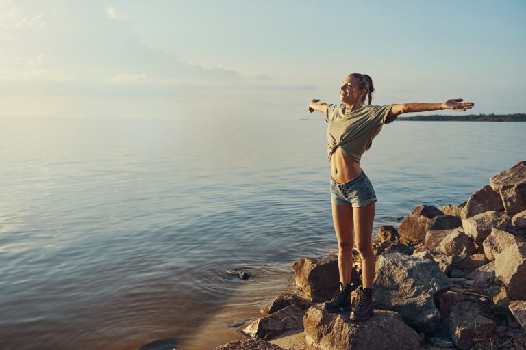 Free woman spreading arms and enjoying wind