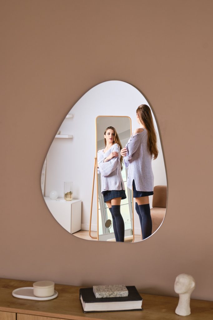 Reflection of a woman in wall mirror